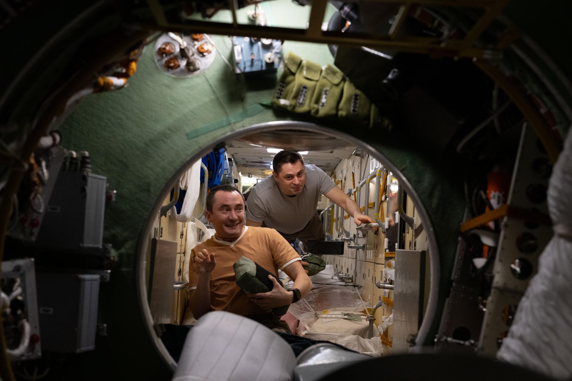 From left, Roscosmos cosmonauts Pyotr Dubrov and Andrey Fedyaev practice emergency procedures in coordination with ground personnel for scenarios, including a pressure leak, chemical leak, or fire aboard the International Space Station.