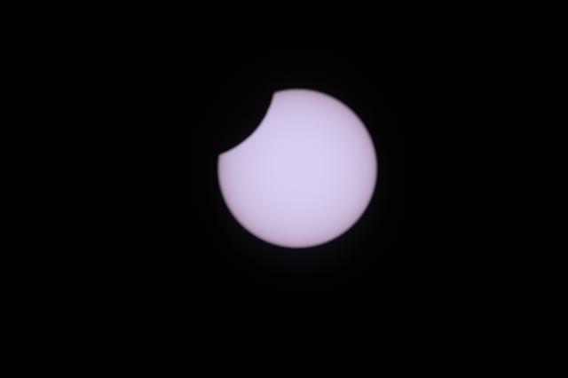 A partial solar eclipse is pictured from the International Space Station