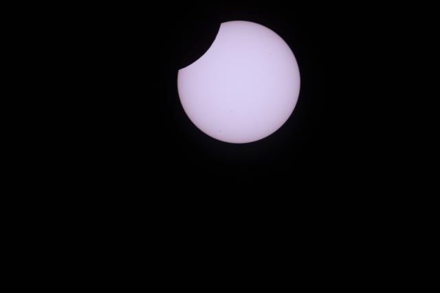 A partial solar eclipse is pictured from the International Space Station