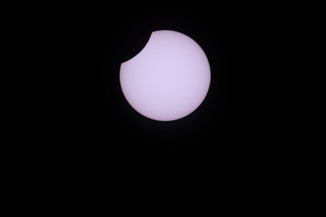 A partial solar eclipse is pictured from the International Space Station