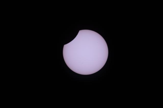 A partial solar eclipse is pictured from the International Space Station