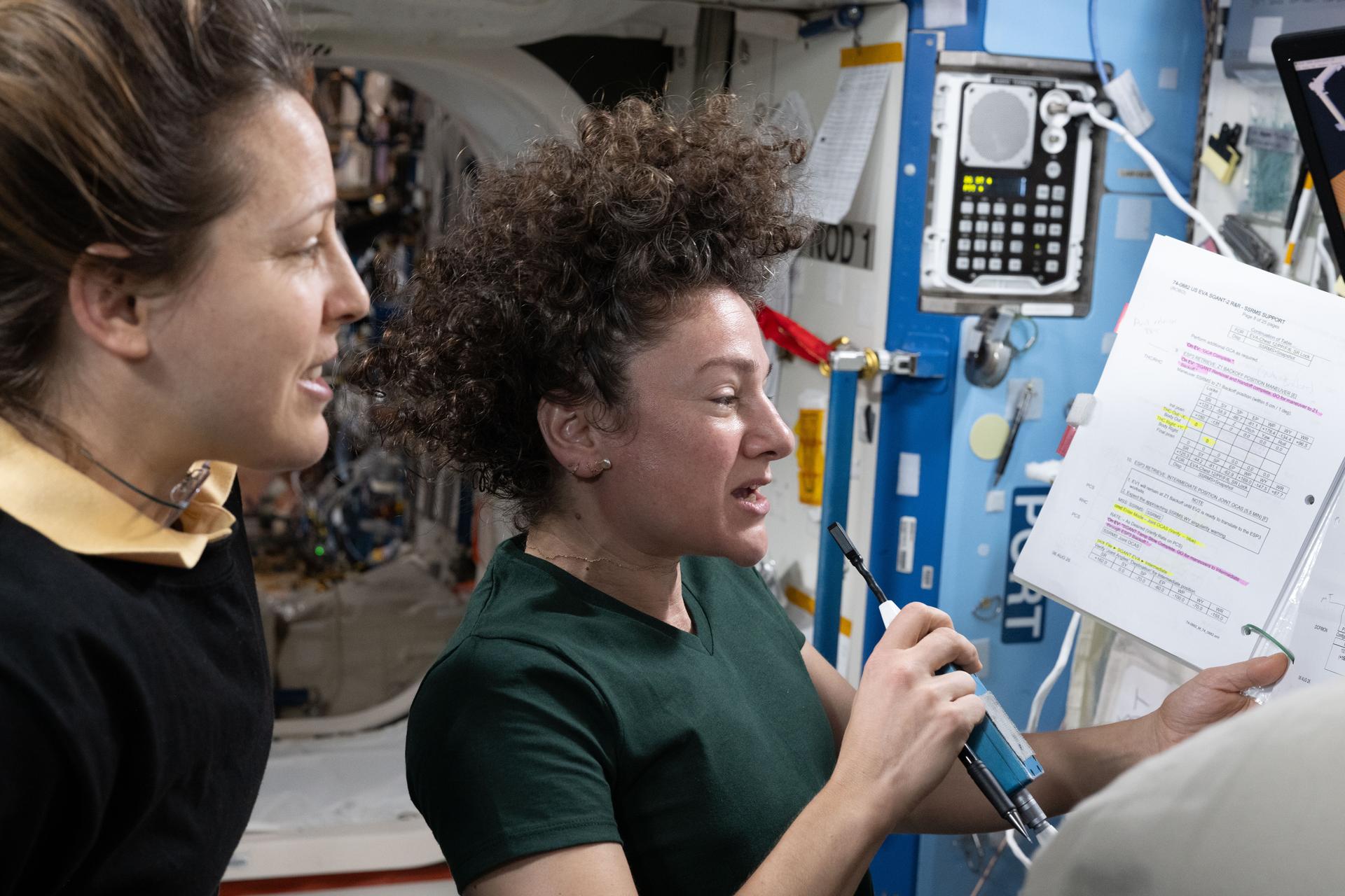 From left, Expedition 75 flight engineer Sophie Adenot of ESA (European Space Agency) and commander Jessica Meir of NASA study Canadarm2 robotic arm procedures to support spacewalk operations to replace a space‑to‑ground antenna outside the International Space Station.