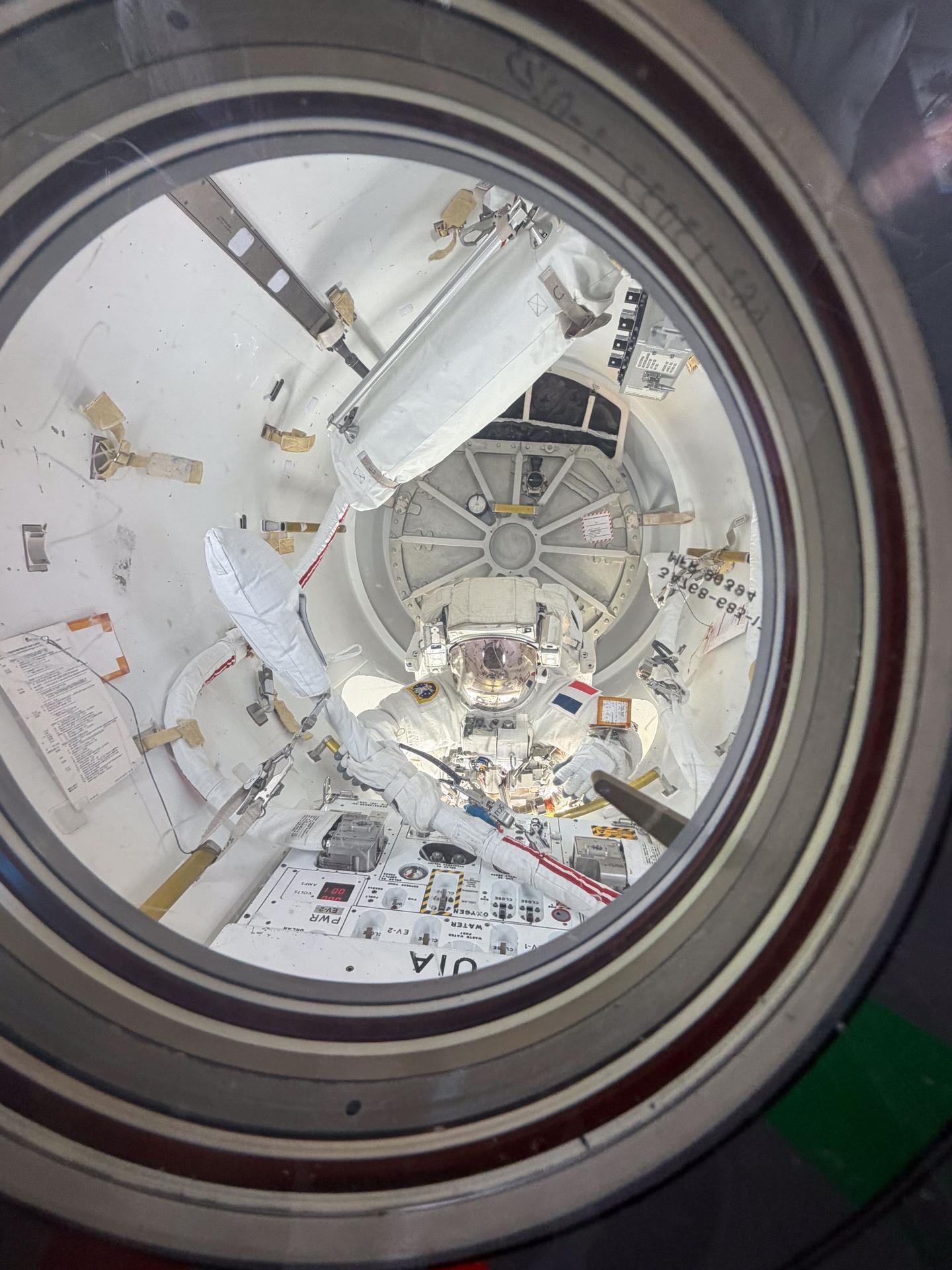 ESA (European Space Agency) astronaut and Expedition 75 flight engineer Sophie Adenot is pictured inside the International Space Station's Quest airlock with her helmet visor down as she nears the end of a six‑hour, 23‑minute spacewalk. Adenot and Expedition 75 flight engineer Anil Menon of NASA (out of frame) worked together to disconnect a failed high‑speed antenna and secure it with a long‑duration tie‑down on the orbital outpost’s Z1 truss segment.