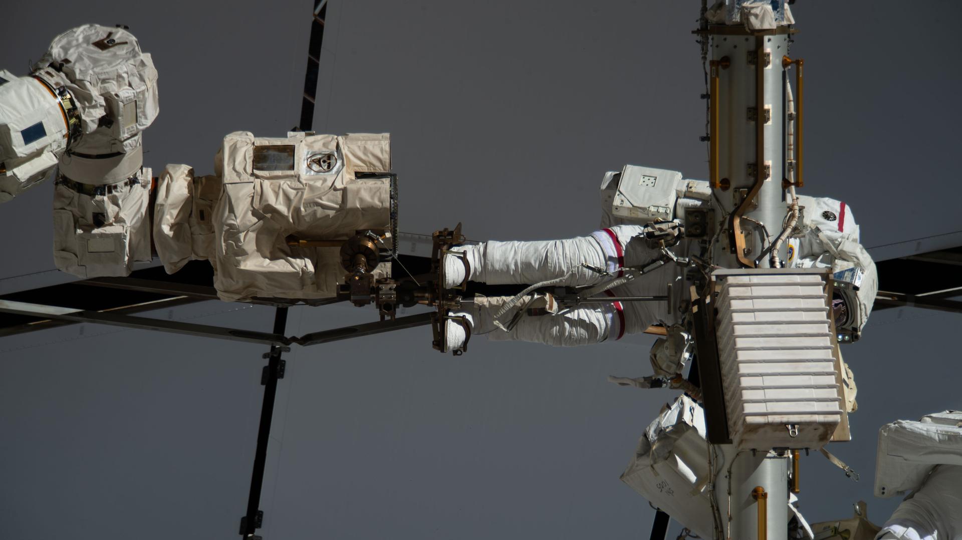 NASA astronaut and Expedition 75 flight engineer Anil Menon is attached to the Canadarm2 robotic arm’s latching end effector during a spacewalk to install a high-speed space-to-ground antenna on the International Space Station’s Z1 truss segment above the Unity module. Menon and ESA (European Space Agency) astronaut and Expedition 75 flight engineer Sophie Adenot (out of frame) spent six hours and 30 minutes replacing a failed antenna with a spare and making the precise connections needed to activate it for high-speed transmissions with mission control.