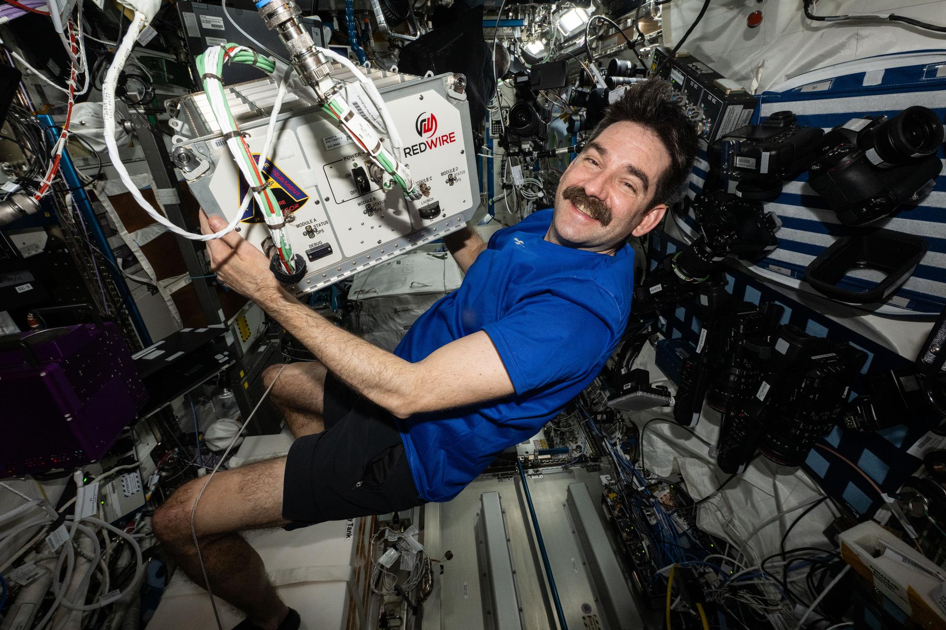 NASA astronaut and Expedition 75 flight engineer Jack Hathaway carries the Advanced Space Experiment Processer-4 (ADSEP-4) and relocates it for installation inside the International Space Station's Destiny laboratory module. ADSEP-4 houses research samples for processing in microgravity, can be launched aboard a SpaceX Dragon or Northrop Grumman's Cygnus XL spacecraft for powered science, and installed in EXPRESS racks aboard the orbital outpost for experimentation.
