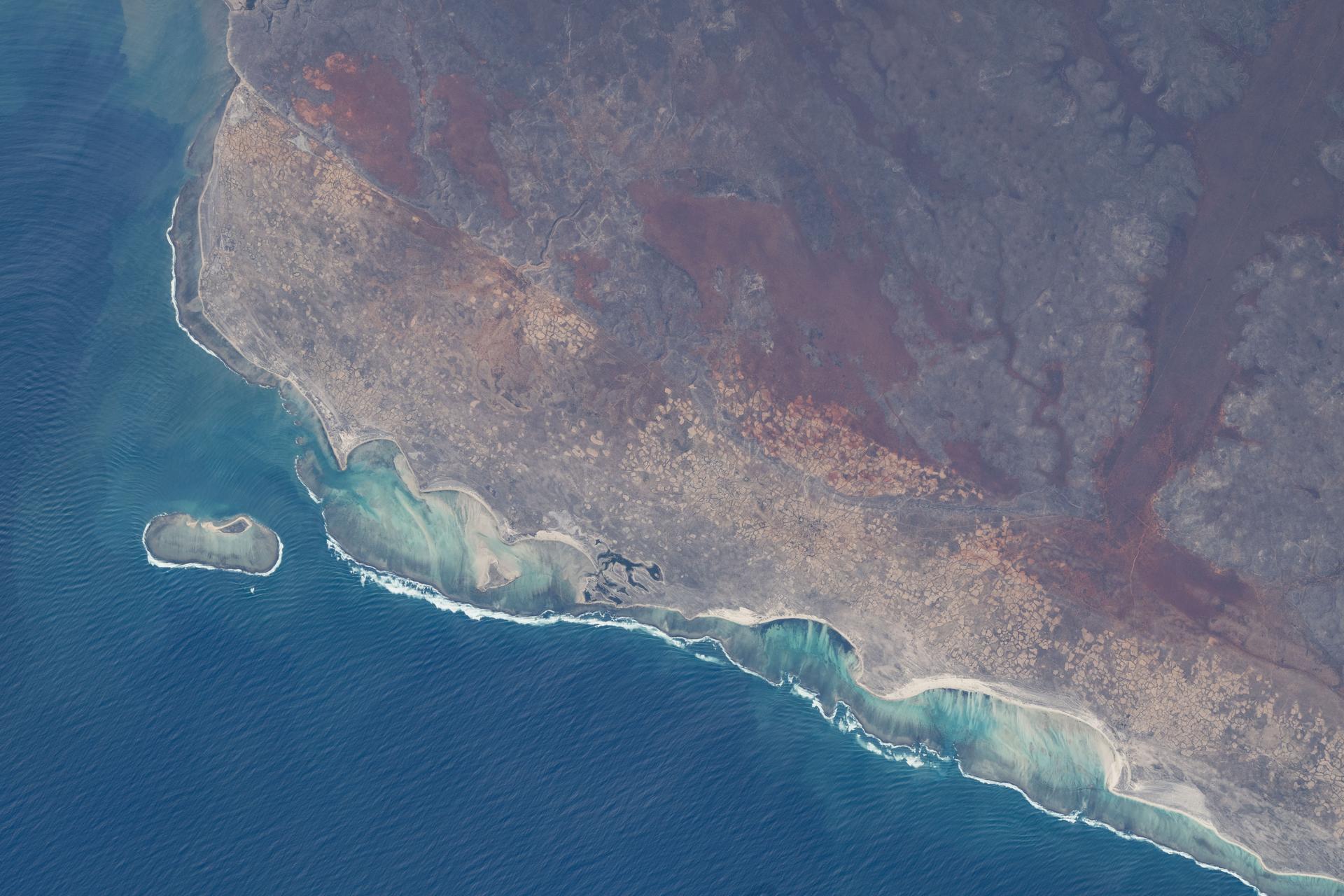 Madagascar’s southwestern coast along the Mozambique Channel—characterized by a semi‑arid to desert climate, sandy coastal plains, and shifting dunes—is pictured from the International Space Station as it orbited 263 miles above the African continent.