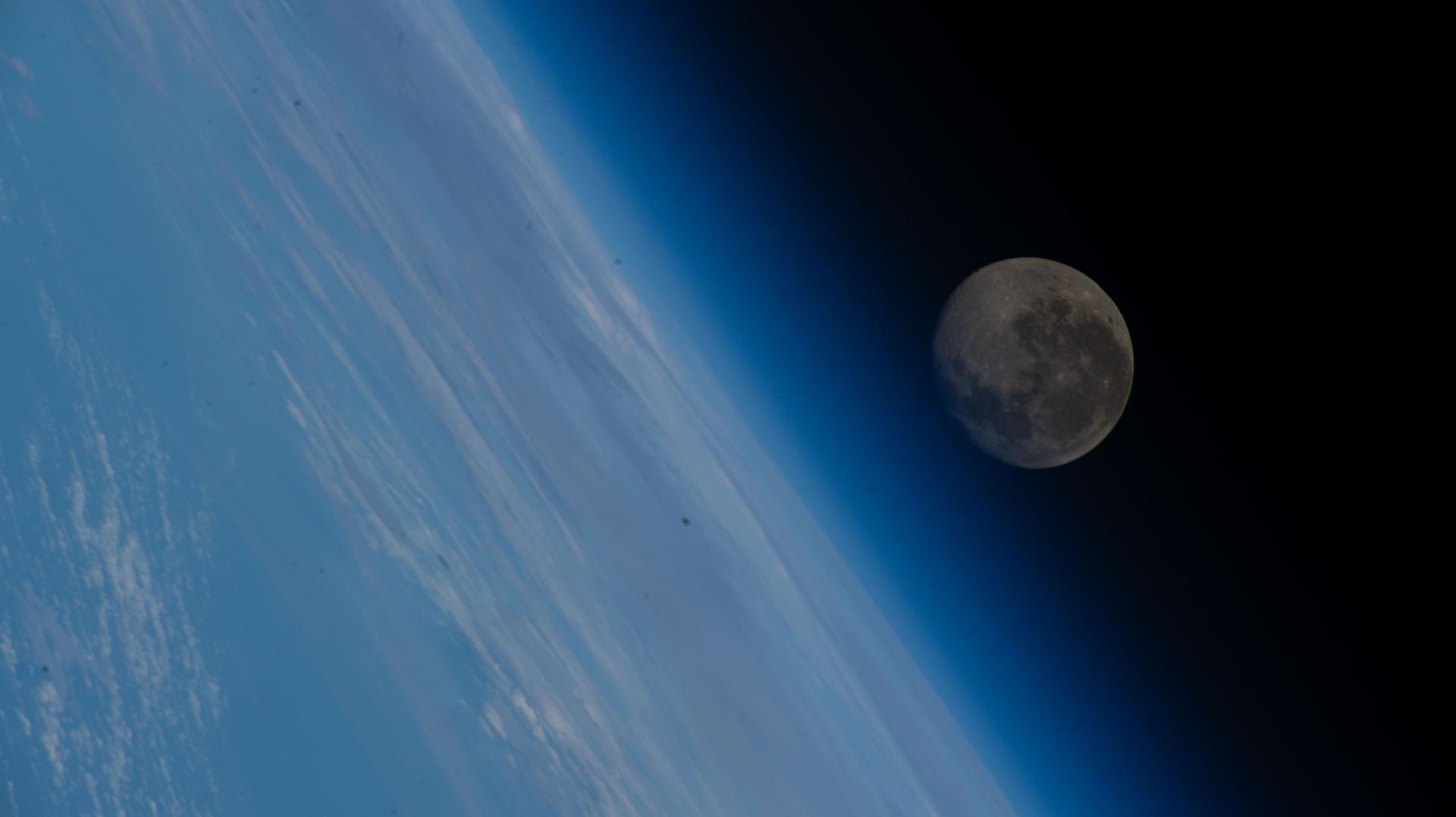 The waning gibbous Moon appears above Earth’s blue atmosphere in this image taken from the International Space Station while orbiting 258 miles above the coast of Hong Kong, China.