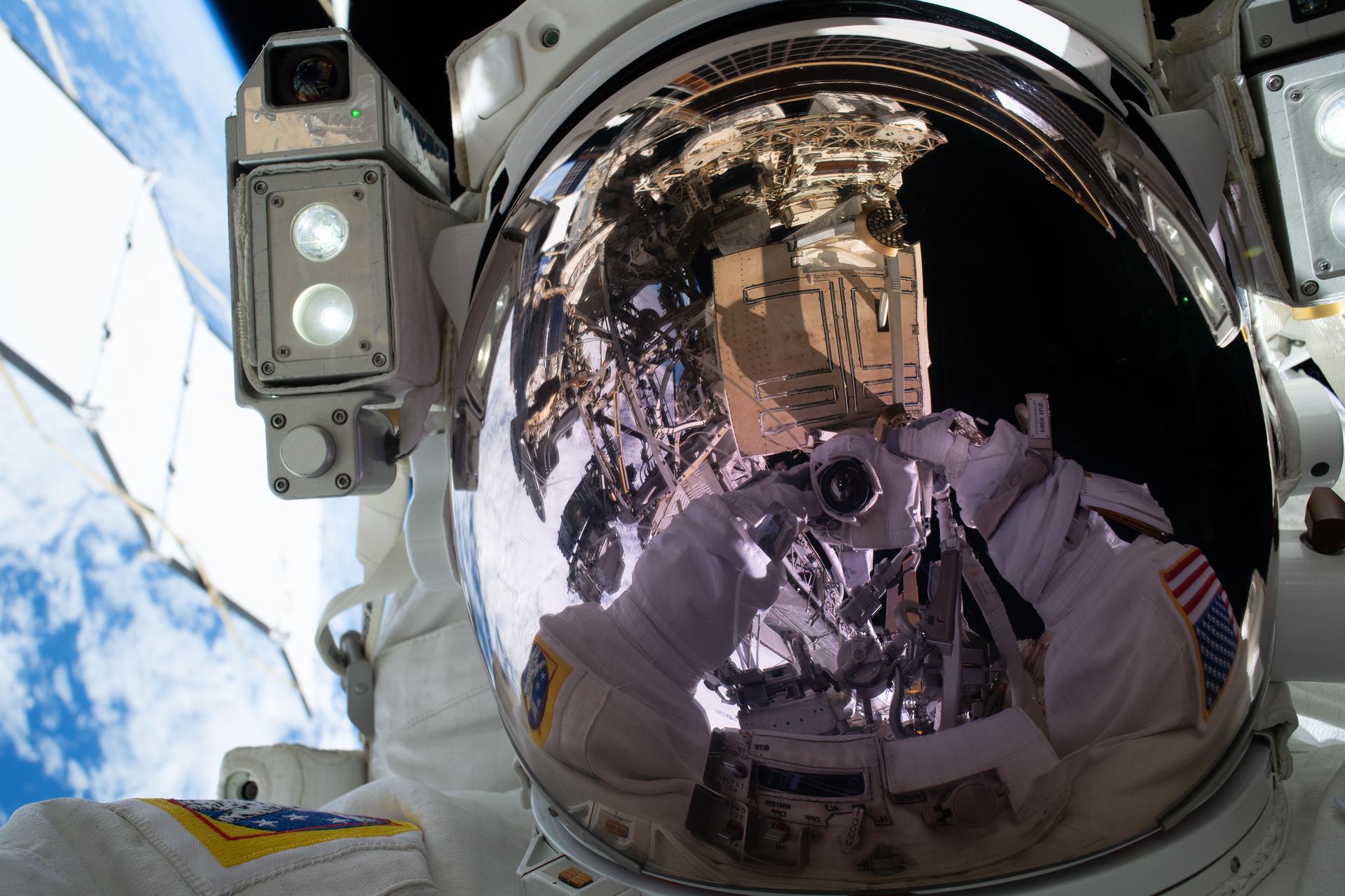 Expedition 75 commander Jessica Meir of NASA points her camera toward her spacesuit’s helmet visor and takes an out-of-this-world “space selfie.” Meir participated in a six-hour and 49‑minute spacewalk with ESA (European Space Agency) flight engineer Sophie Adenot (out of frame), installing a spacecraft navigation aid, swabbing the station’s exterior for microorganisms, and preparing a cosmic particle detector for future upgrades outside the International Space Station.