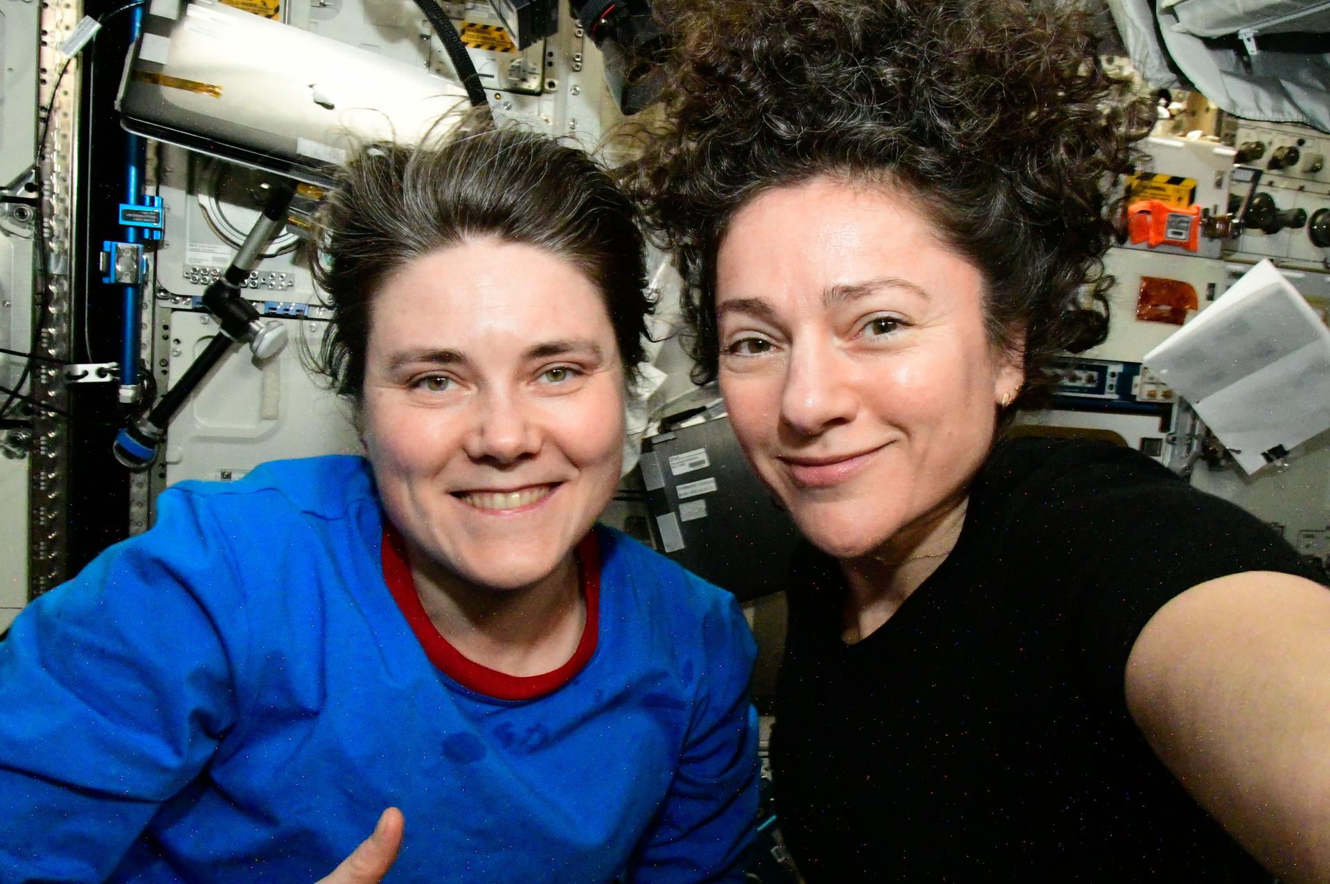 From left, Expedition 75 crew members Anna Kikina of Roscosmos and Jessica Meir of NASA, International Space Station flight engineer and commander respectively, gather together for a portrait inside the Kibo laboratory module.
