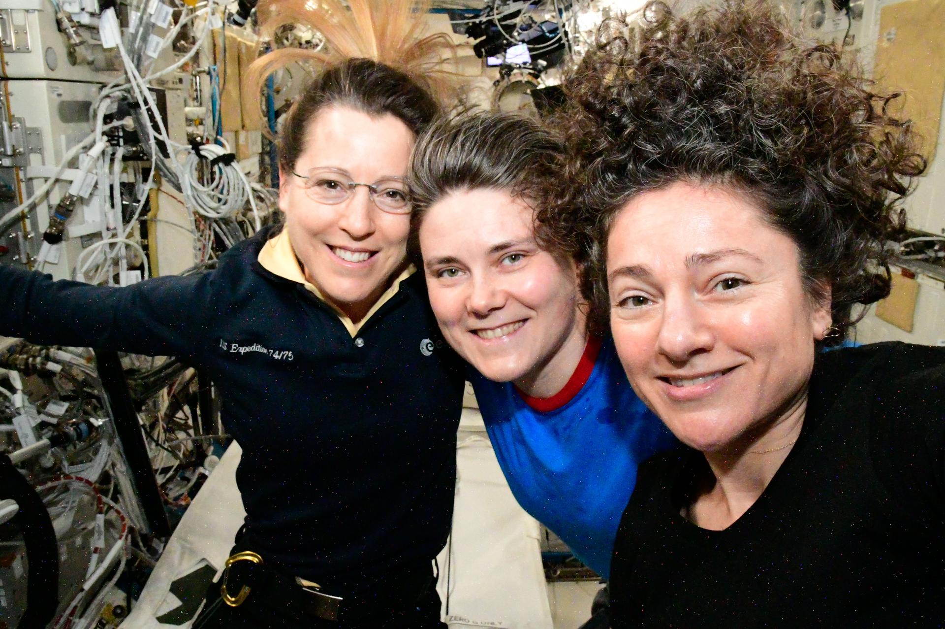 From left, Expedition 75 crew members Sophie Adenot of ESA (European Space Agency) and Anna Kikina of Roscosmos, both flight engineers, and International Space Station commander Jessica Meir of NASA gather together for a portrait inside the Kibo laboratory module.