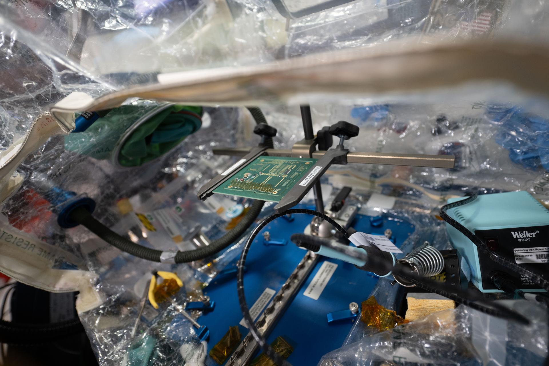 iss075e0103078 (Sept. 14, 2026) --- A circuit board is pictured inside a container system attached to the Harmony module's maintenance work area inside the International Space Station. NASA astronaut and Expedition 75 flight engineer Anil Menon used a lead-free soldering technique to solder components on the circuit board and demonstrate the manufacturing and repair of electronics in microgravity. The MIYOKA experiment will return the space-soldered samples to Earth for analysis and compare them to identical ground-soldered samples. Results may lead to reduced reliance on costly resupply missions. Credit: ESA/Sophie Adenot