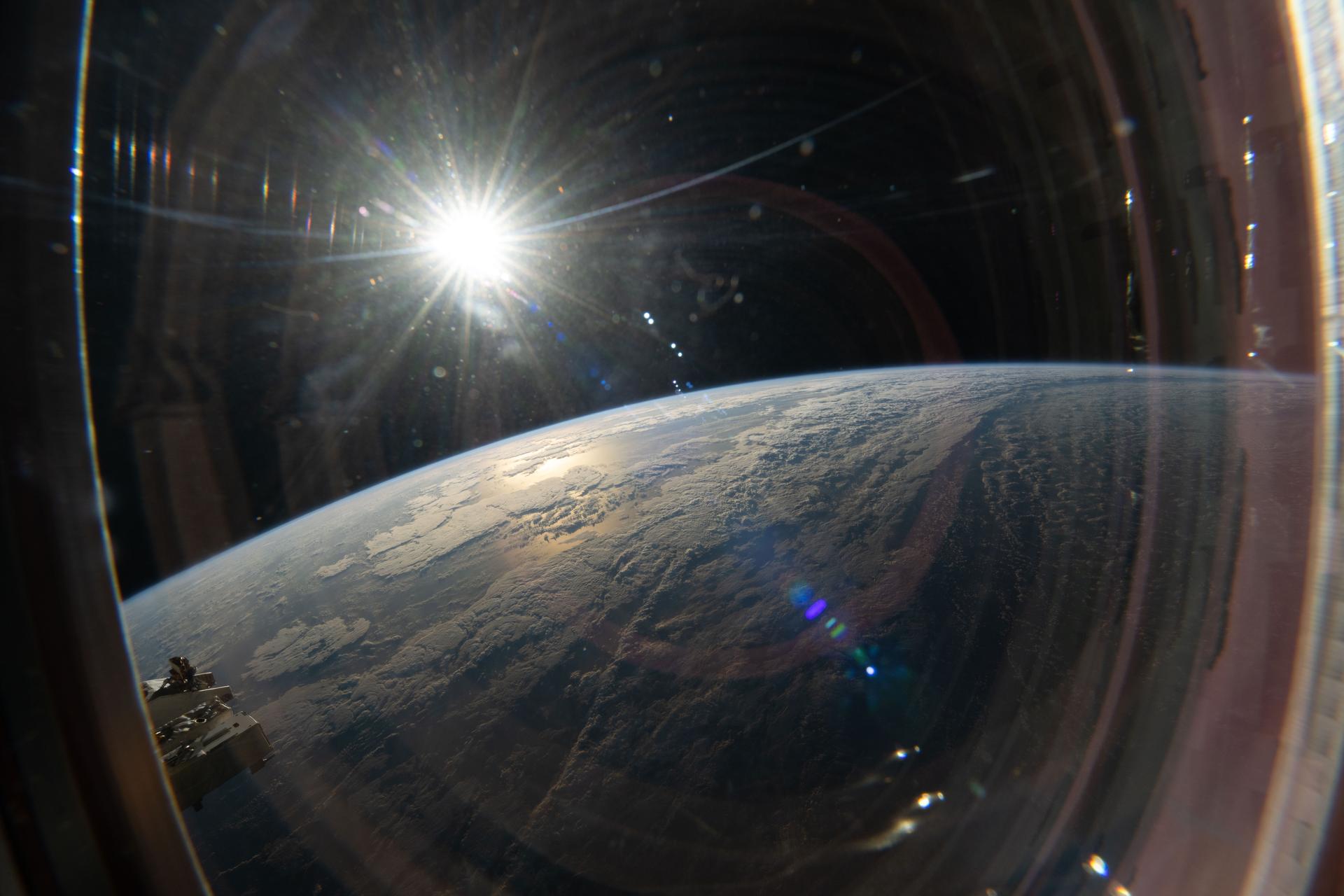 iss075e0103110 (Sept. 9, 2026) --- This view from a window on the SpaceX Dragon highlights the sun illuminating a cloudy Pacific Ocean as the International Space Station orbited 263 miles above Earth. Credit: NASA/Jessica Meir