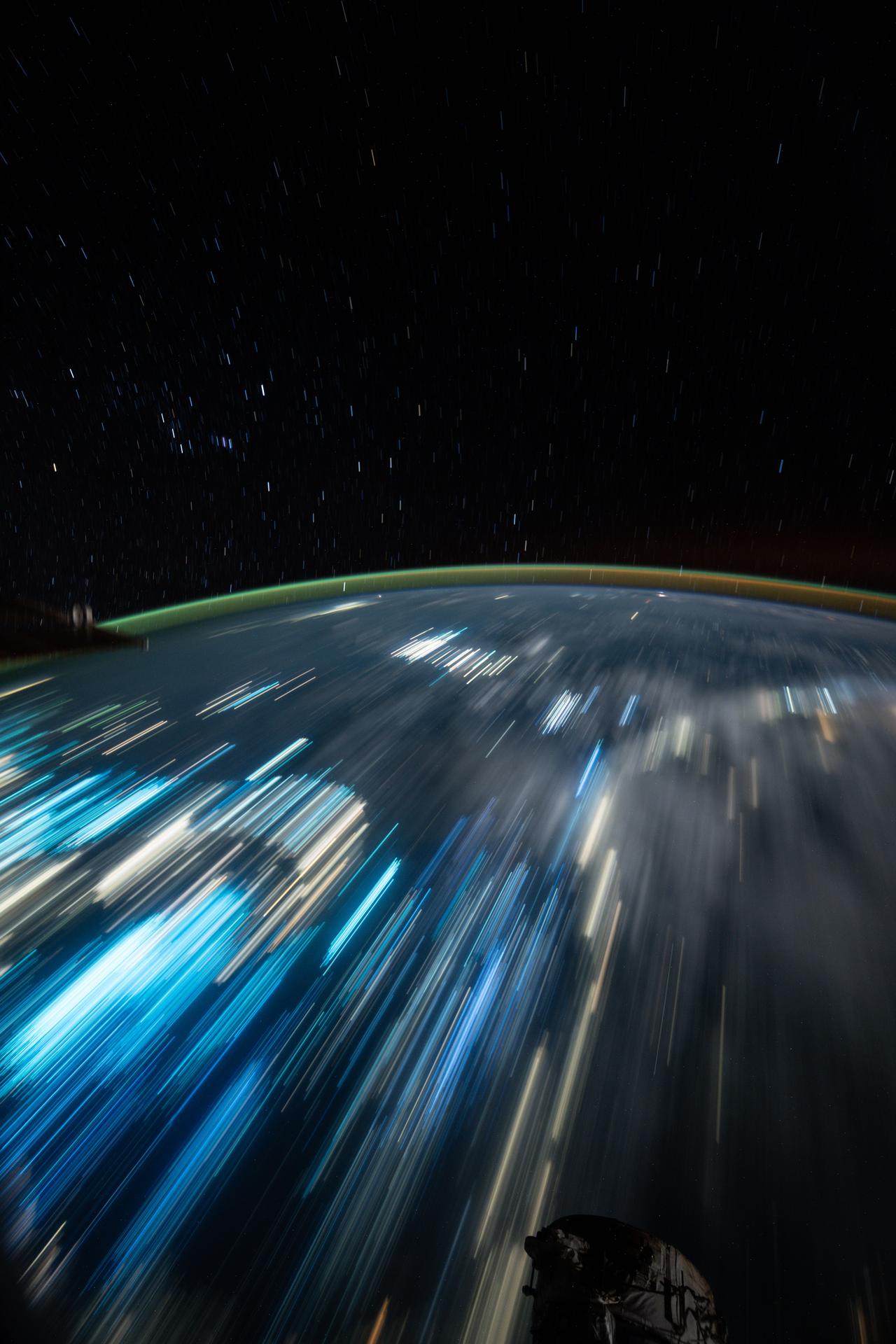 iss075e0144232 (Sept. 20, 2026) --- This long-duration image shows star trails above Earth and the blue lights of fishing boats and the yellow lights of Indonesian cities stretching below the International Space Station as it orbited 258 miles above the Banda Sea. Credit: NASA/Anil Menon