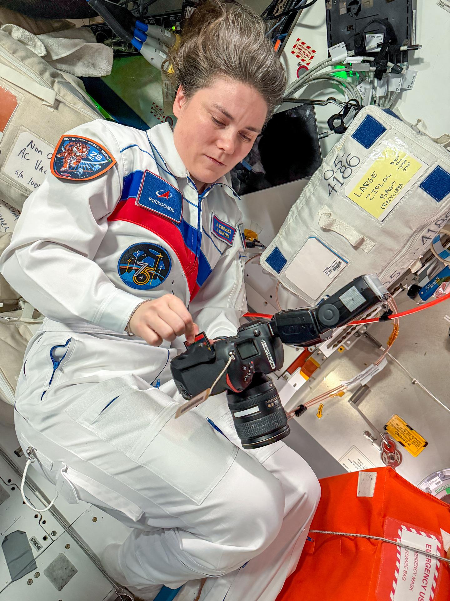 iss075e0157516 (Oct. 2, 2026) --- Roscosmos cosmonaut and Expedition 75 flight engineer Anna Kikina configures a camera aboard the International Space Station while awaiting the arrival of NASA's SpaceX Crew‑13 mission and its four crew members. Credit: ESA/Sophie Adenot