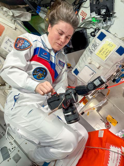 Roscosmos cosmonaut Anna Kikina configures a camera aboard the International Space Station