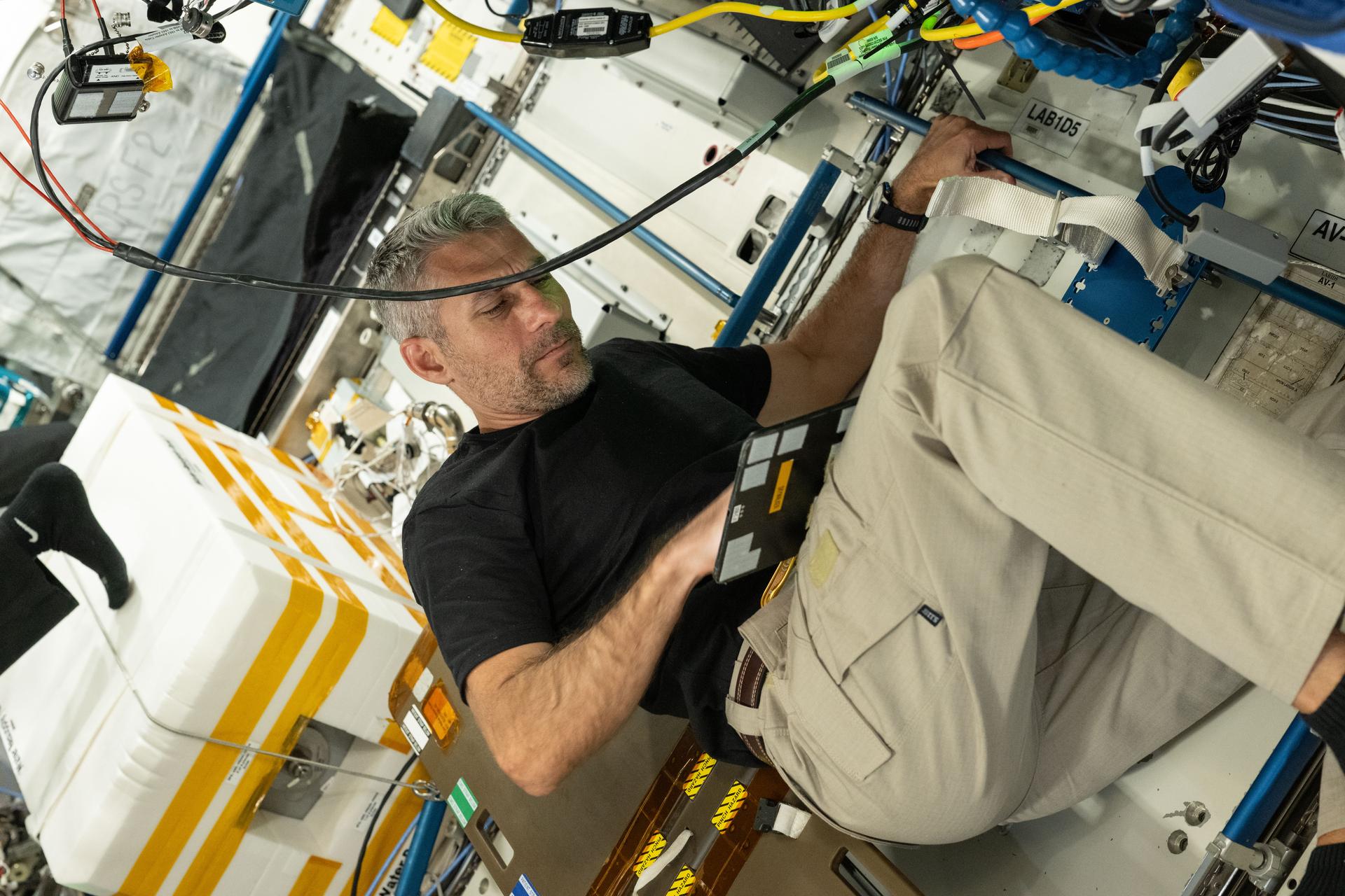 NASA astronaut and Expedition 75 flight engineer Luke Delaney familiarizes himself with lab hardware inside the International Space Station's Destiny laboratory module. Delaney arrived at the orbital outpost a week earlier with his crewmates from NASA's SpaceX Crew-13 mission beginning a six-month space research mission.