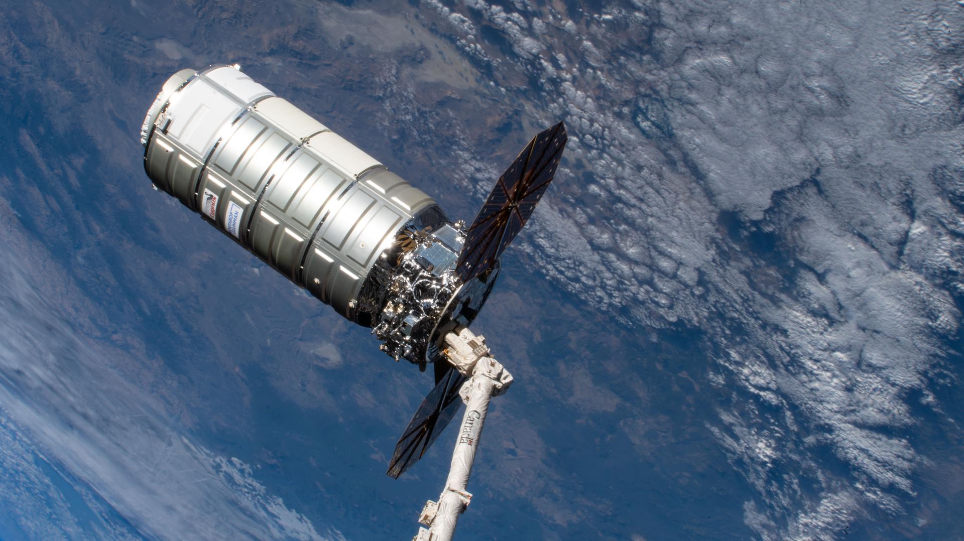Northrop Grumman’s Cygnus XL cargo spacecraft is pictured in the grip of the Canadarm2 robotic arm moments before its release into Earth orbit after a nearly six‑month stay attached to the International Space Station’s Unity module. The orbital outpost was soaring 263 miles above the Indian Ocean, off the coast of Madagascar, at the time of this photograph.