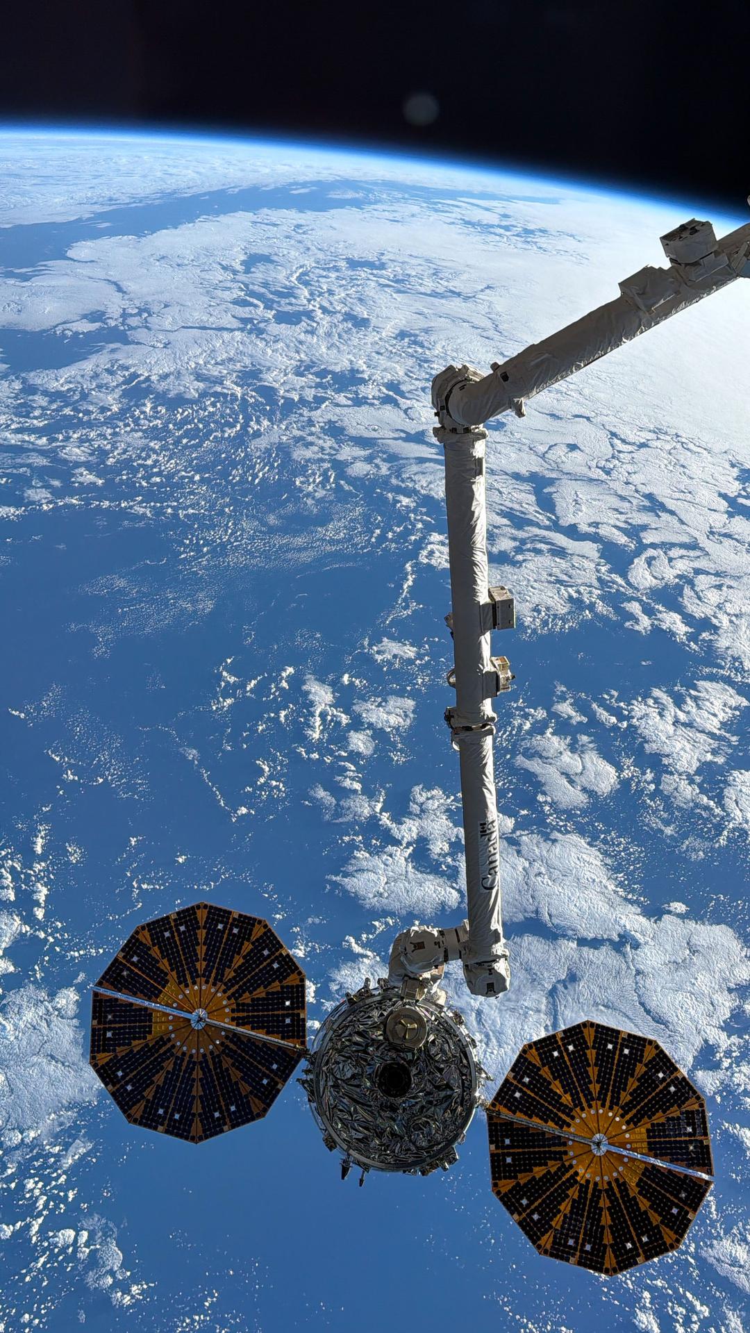 Northrop Grumman's Cygnus XL cargo spacecraft is held in the grip of the Canadarm2 robotic arm before its release from the International Space Station. The orbital outpost was soaring 264 miles above the North Atlantic Ocean at the time of this photograph.