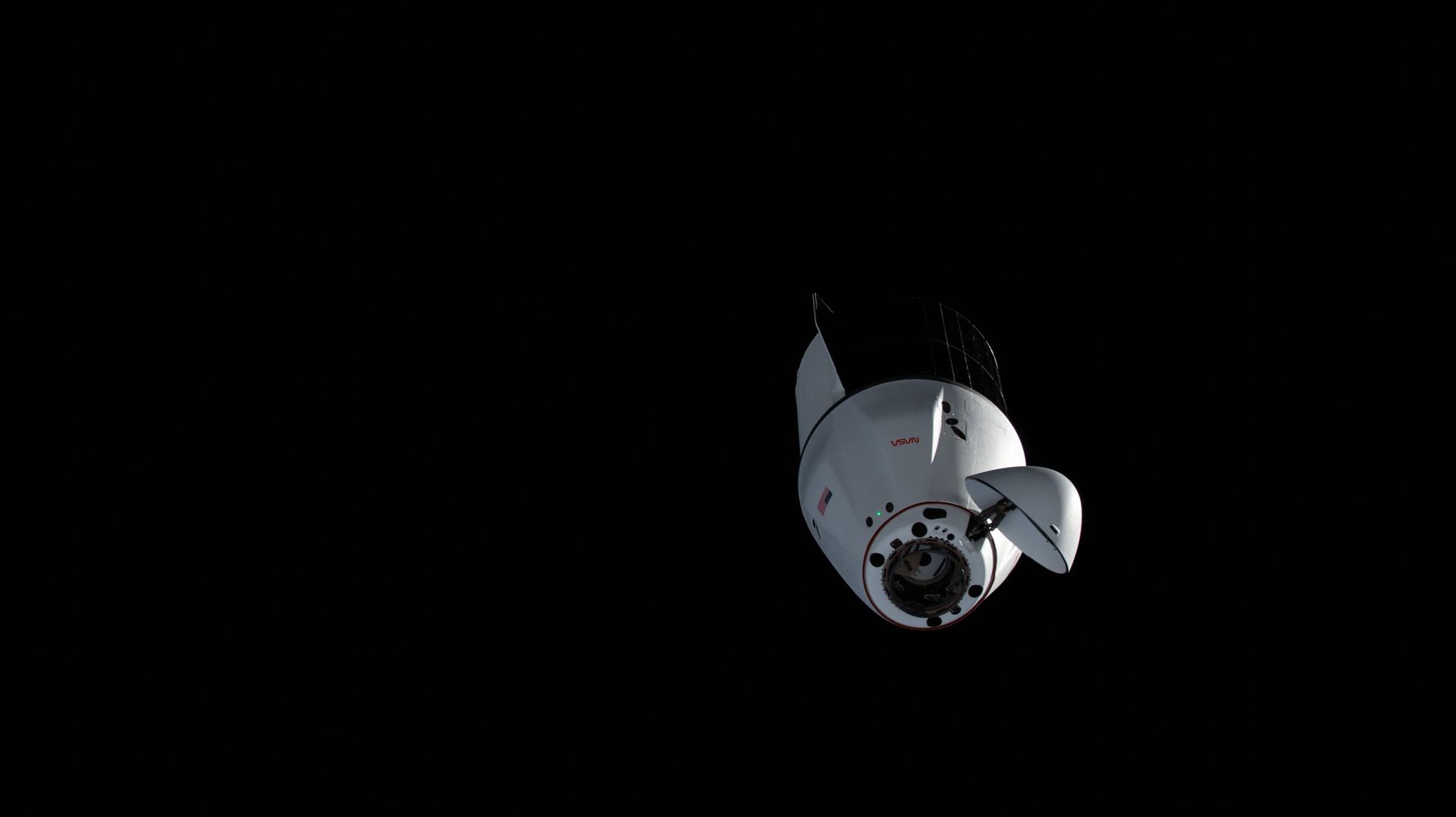 A SpaceX Dragon spacecraft carrying more than 6,300 pounds of science and supplies for the Expedition 75 crew, along with a pair of roll-out solar arrays to augment the International Space Station's power generation system, approaches the orbital outpost for an automated docking to the space-facing port on the Harmony module.