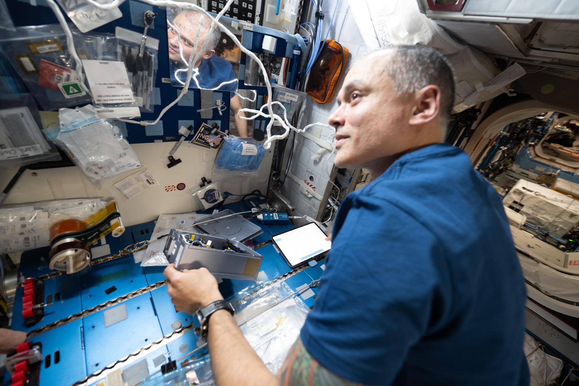 NASA astronaut and Expedition 75 flight engineer Anil Menon installs experimental fluid systems inside the Advanced Space Experiment Processor-2 (ADSEP-2) sample processing hardware. ADSEP‑2 can be configured for cell and tissue culturing, protein crystal growth, microorganism studies, and materials science research with colloids.