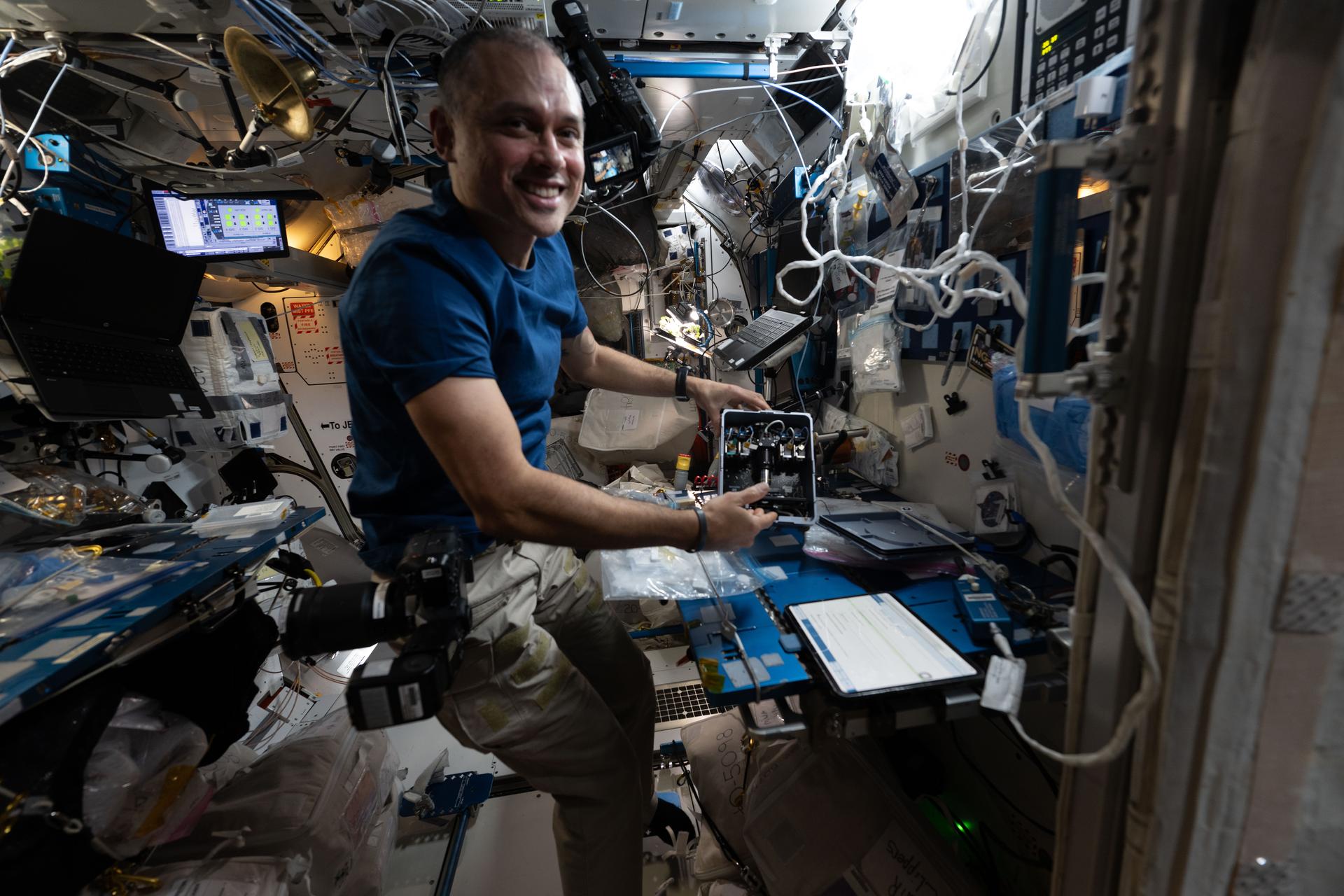 NASA astronaut and Expedition 75 flight engineer Anil Menon installs experimental fluid systems inside the Advanced Space Experiment Processor-2 (ADSEP-2) sample processing hardware. ADSEP‑2 can be configured for cell and tissue culturing, protein crystal growth, microorganism studies, and materials science research with colloids.