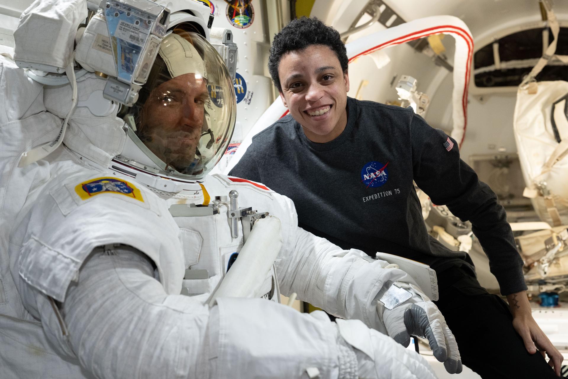 Expedition 75 flight engineers Joshua Kutryk of CSA (Canadian Space Agency) and Jessica Watkins of NASA pose together inside the International Space Station's Quest airlock. Watkins assisted Kutryk as he tried on a spacesuit ensuring a good fit, comfort, and systems functionality. Spacesuit fit checks also account for body changes such as spinal elongation that take place in microgravity.