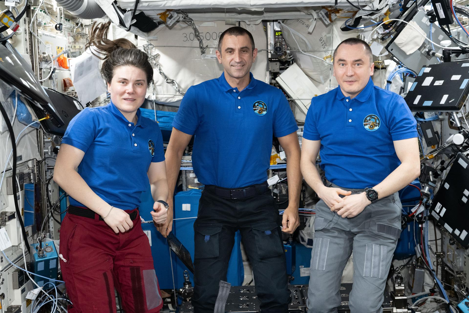 From left, Expedition 75 flight engineers Anna Kikina and Sergey Teteryatnikov and station commander Pyotr Dubrov, all Roscosmos cosmonauts, pose for a portrait inside the International Space Station’s Columbus laboratory module.