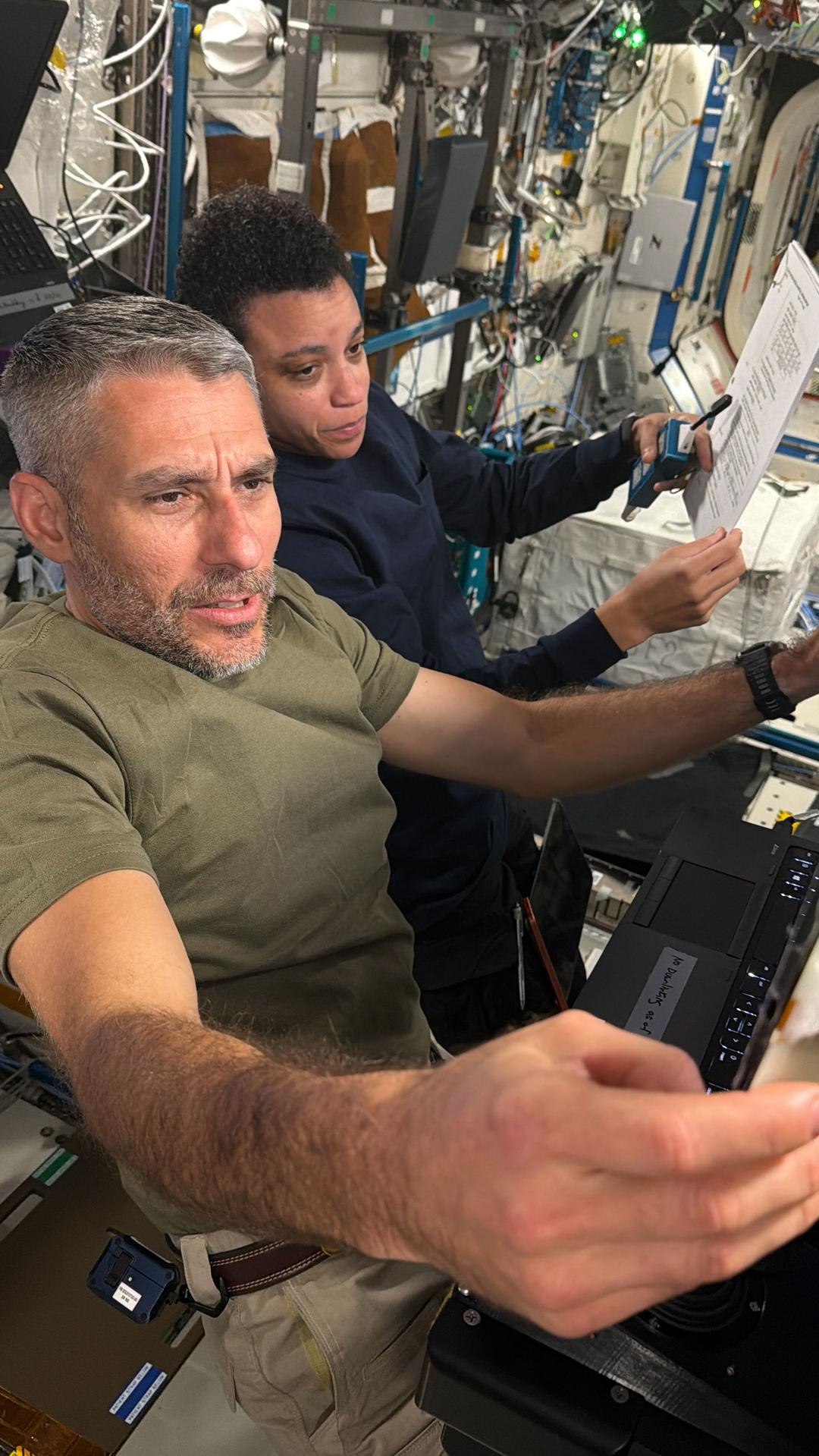 Expedition 75 flight engineers Luke Delaney and Jessica Watkins, both NASA astronauts, review and practice Canadarm2 robotic arm maneuvers at the robotics workstation inside the International Space Station’s Destiny laboratory module. Delaney and Watkins trained to support an upcoming spacewalk with Expedition 75 flight engineers Anil Menon of NASA and Joshua Kutryk of the Canadian Space Agency (CSA) to install a roll-out solar array on the orbital outpost’s truss structure.