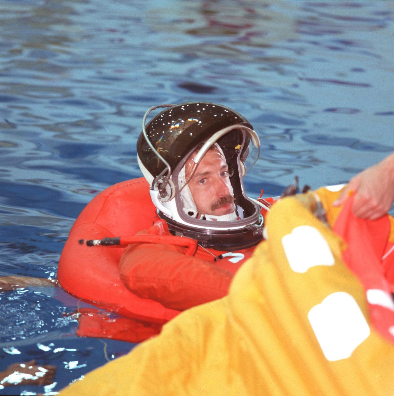 JSC2000-02545 (21 March 2000) --- Astronaut Daniel C. Burbank, STS-106 mission specialist, prepares  his life raft during an emergency bailout training simulation in the pool of the Neutral Buoyancy Laboratory (NBL).  Burbank will join four NASA astronauts and two cosmonauts, representing the Russian Aviation and Space Agency, for a late summer visit to the International Space Station (ISS).