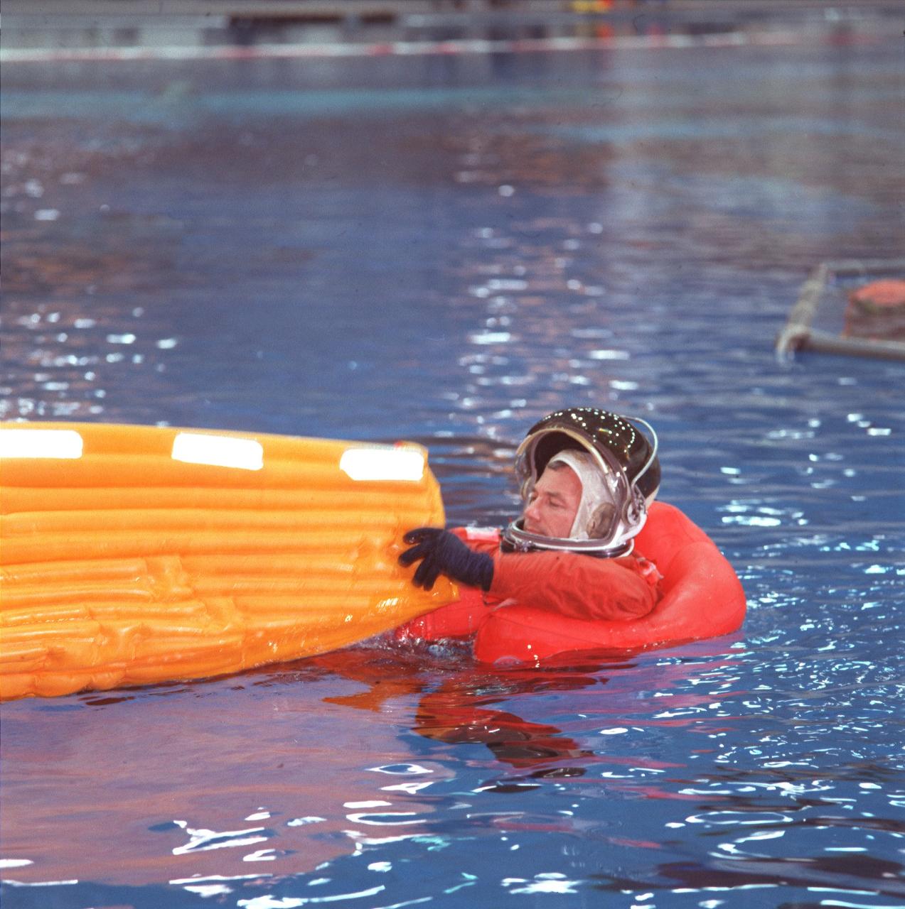 JSC2000-02567 (21 March 2000) ---  Astronaut Terrence W. (Terry) Wilcutt,  STS-106 mission commander, empties water from his newly-deployed life raft during a simulation of an emergency bailout exercise.  The water survival training  routinely takes place in the Neutral Buoyancy Laboratory (NBL) near the Johnson Space Center (JSC).