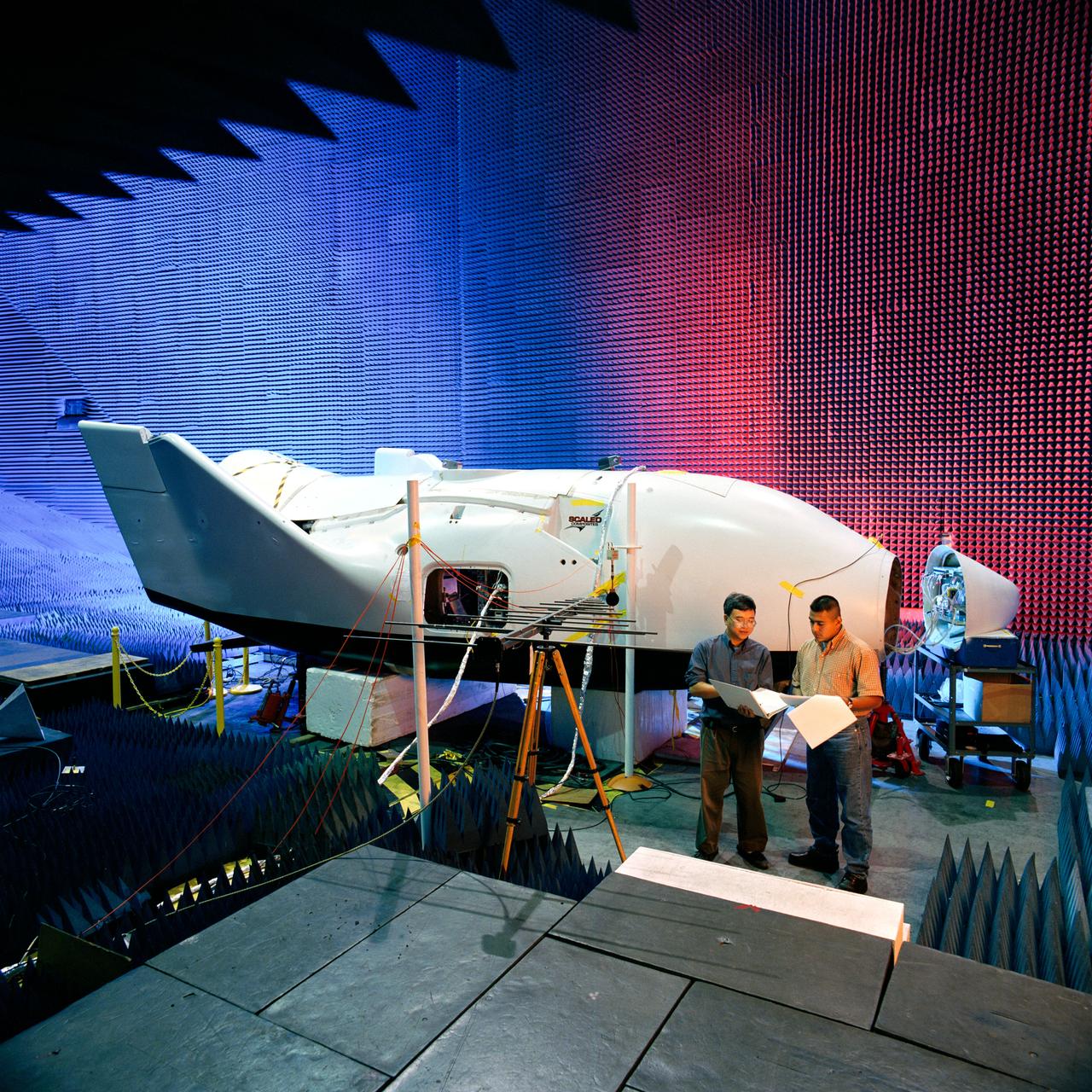 Photographic documentation showing the X-38 Crew Return Vehicle (CRV) undergoing testing in the anechoic chamber in bldg. 14.