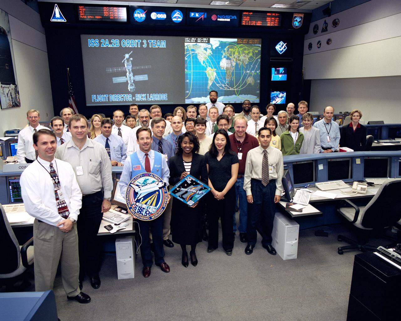 JSC2000-06245 (September 2000) --- The ISS orbit 3 team of flight controllers  are pictured with flight director Rick  LaBrode in the ISS flight control room during STS-106. Astronaut Stephanie Wilson, spacecraft communicator (CAPCOM), is at front center.