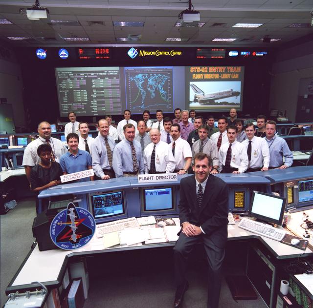 NASA image: STS-92 Ascent and Entry Flight Control teams pose in the MCC