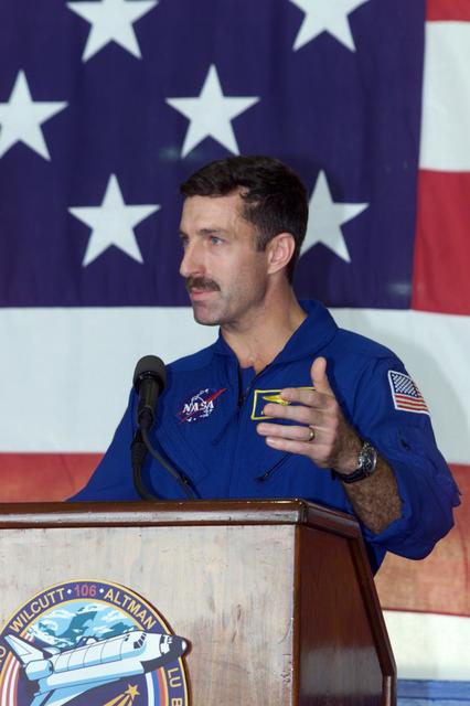 JSC2000-E-23458 (21 September 2000) --- Astronaut Daniel C. Burbank, STS-106 mission specialist, addresses the crowd that visited Ellington Field's Hangar 990 to welcome home the STS-106 astronauts.  The seven-man crew landed approximately 24 hours earlier in Florida, wrapping up a 4.9 million-mile mission in which more than three tons of equipment were delivered to the international outpost.