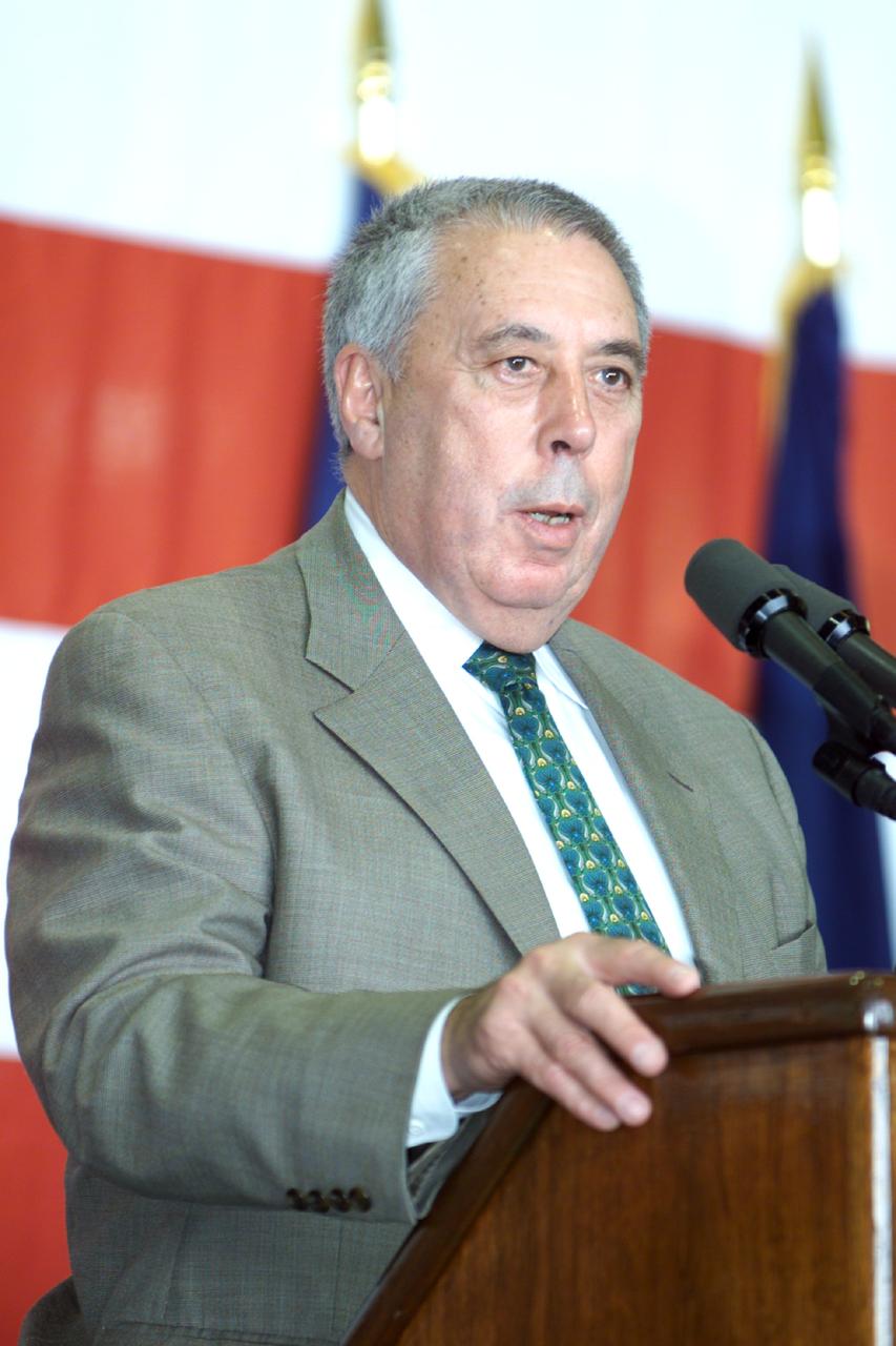 JSC2000-E-27059 (26 October 2000) ---  JSC Director George W.S. Abbey speaks to  crowd in Ellington Field's Hangar 990 during STS-92 crew return ceremonies.