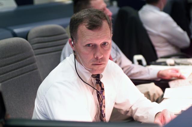 JSC2000-E-29791 (30 November 2000) --- Astronaut Dominic L. Gorie, spacecraft communicator (CAPCOM), follows STS-97 pre-launch activity from the CAPCOM console in the shuttle flight control room (WFCR) at Houston's Mission Control Center (MCC).