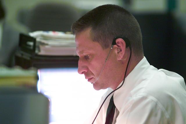 JSC2001-E-12117 (19 April 2001) --- Astronaut Christopher J. (Gus) Loria, at the Spacecraft Communicator (CAPCOM) console, peruses information on monitors and displays at his console in the flight control room in the Johnson Space Center's Mission Control Center (MCC) as countdown for the Space Shuttle Endeavour launch of STS-100 continues several hundred miles away in Florida. Loria deals with weather issues in the respective areas for both ascent and entry phases of the STS-100 mission.