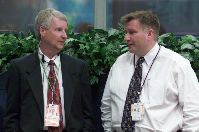 JSC2001-E-12119 (19 April 2001) --- Steven A. Hawley of the Flight Crew Operations Directorate chats with Daniel K. Carpenter, Director of the Johnson Space Center (JSC) Public Affairs Office, as the two await liftoff of the Space Shuttle Endeavour.  The two are at the rear of the flight control room of JSC's Mission Control Center.