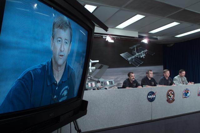 JSC2001-E-23194 (26 July 2001) --- A close-up image of astronaut Frank L. Culbertson, Jr., Expedition Three commander, shows on a nearby television monitor during a pre-flight press conference at Johnson Space Center (JSC). The entire Expedition Three crew can be seen in the background, along with moderator Kyle Herring (right). The station crew members were later joined by the STS-105 crew on the dais. All seven men are to be launched into space aboard the Space Shuttle Discovery on August 9.
