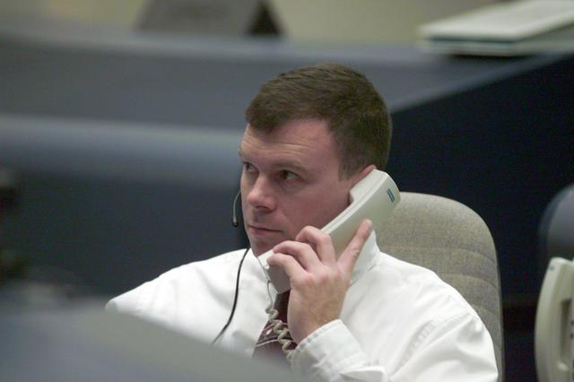 JSC2001-E-24995 (10 August 2001) --- Astronaut James M. Kelly, STS-105 spacecraft communicator (CAPCOM) for weather issues, monitors pre-flight data at his console in the shuttle flight control room (WFCR) in Houston's Mission Control Center (MCC). Several hundred miles away in Florida, the STS-105 and Expedition Three crew members were awaiting countdown in the crew cabin of the Space Shuttle Discovery on the launch pad at the Kennedy Space Center (KSC). As soon as the vehicle cleared the tower in Florida, the Houston-based team of flight controllers took over the ground control of the flight.