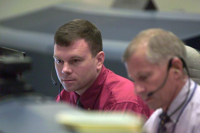 JSC2001-E-24997 (10 August 2001) --- Astronaut James M. Kelly, STS-105 spacecraft communicator (CAPCOM) for weather issues, monitors pre-flight data at his console in the shuttle flight control room (WFCR) in Houston's Mission Control Center (MCC). Several hundred miles away in Florida, the STS-105 and Expedition Three crew members were awaiting countdown in the crew cabin of the Space Shuttle Discovery on the launch pad at the Kennedy Space Center (KSC). As soon as the vehicle cleared the tower in Florida, the Houston-based team of flight controllers took over the ground control of the flight.