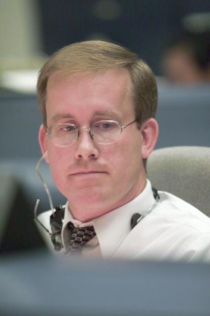 JSC2001-E-24998 (10 August 2001) --- Flight director John Shannon studies pre-flight data at his console in the shuttle flight control room (WFCR) in Houston's Mission Control Center (MCC) prior to the launch of Space Shuttle Discovery. Several hundred miles away in Florida, the STS-105 and Expedition Three crew members were awaiting countdown in the crew cabin of the Space Shuttle Discovery on the launch pad at the Kennedy Space Center (KSC). As soon as the vehicle cleared the tower in Florida, the Houston-based team of flight controllers took over the ground control of the flight.