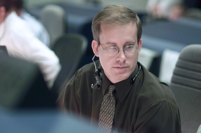 JSC2001-E-25112 (16 August 2001) --- Flight director John Shannon studies data at his console in the shuttle flight control room (WFCR) in Houston&#0146;s Mission Control Center (MCC) during the first of two scheduled space walks while Discovery was docked to the International Space Station (ISS).
