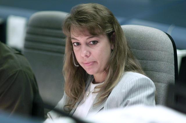 JSC2001-E-25113 (16 August 2001) --- Flight director Kelly Beck monitors data at her console in the shuttle flight control room (WFCR) in Houston’s Mission Control Center (MCC). At the time this photo was taken, STS-105 mission specialists Daniel T. Barry and Patrick G. Forrester were performing the first of the two scheduled space walks to perform work on the International Space Station (ISS).