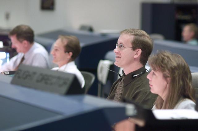 JSC2001-E-25125 (16 August 2001) --- Flight directors John Shannon (left foreground) and Kelly Beck watch the large screens from their consoles in the shuttle flight control room (WFCR) in Houston&#0146;s Mission Control Center (MCC) along with astronauts Joseph R. Tanner (left background) and Steve MacLean, STS-105 spacecraft communicators (CAPCOM). At the time this photo was taken, mission specialists Daniel T. Barry and Patrick G. Forrester were performing the first of two scheduled space walks during Discovery&#0146;s visit to the International Space Station (ISS). MacLean represents the Canadian Space Agency.