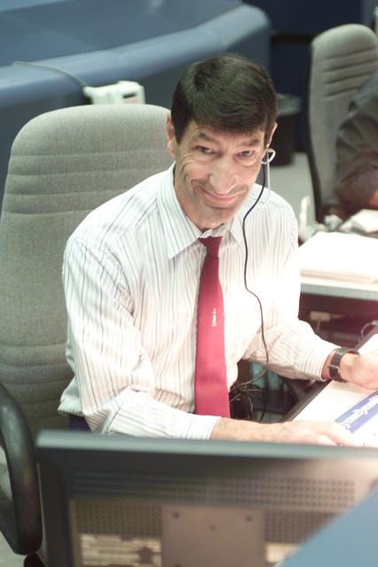 JSC2001-E-25401 (17 August 2001) --- Astronaut Mario Runco Jr., STS-105 spacecraft communicator (CAPCOM), monitors data at his console in the shuttle flight control room (WFCR) in Houston's Mission Control Center (MCC).
