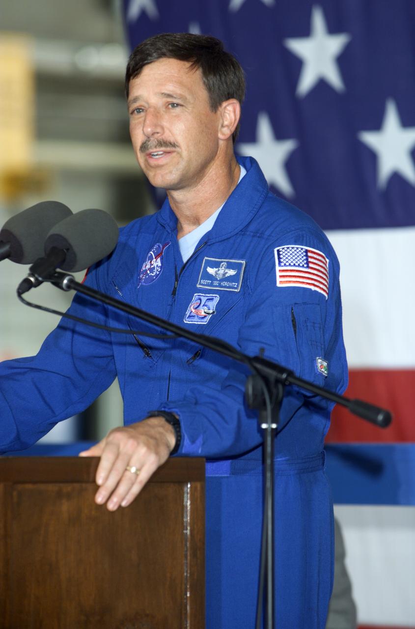 JSC2001-E-25816 (23 August 2001) --- Scott J. Horowitz, STS-105 commander, speaks from the podium in Hangar 990 at Ellington Field during the STS-105 and Expedition Two crew return ceremonies. The STS-105 crew delivered the Expedition Three crew and supplies to the International Space Station (ISS) and brought the Expedition Two crew back to Earth.