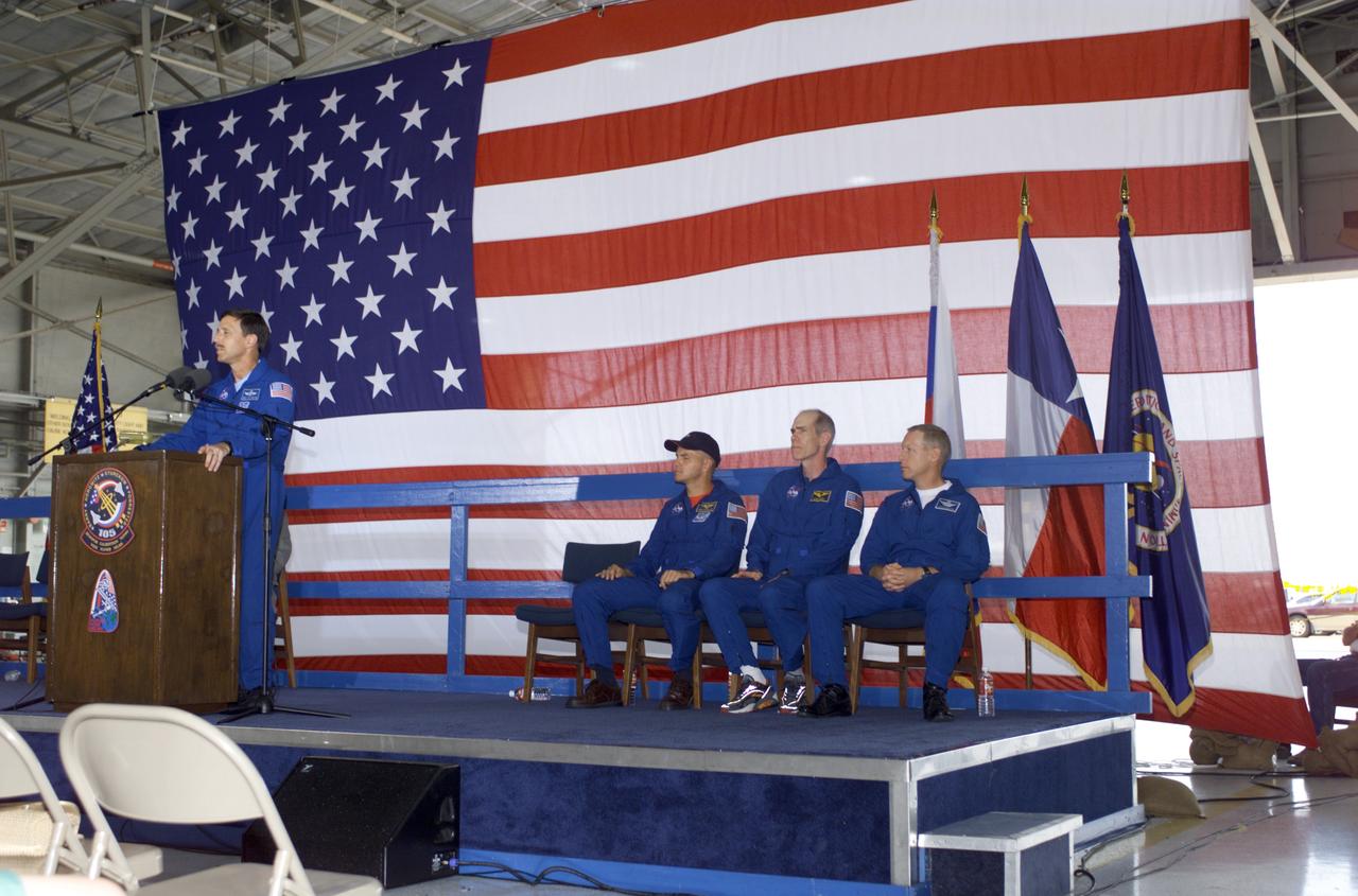 JSC2001-E-25817 (23 August 2001) --- Scott J. Horowitz, STS-105 commander, speaks from the podium in Hangar 990 at Ellington Field during the STS-105 and Expedition Two crew return ceremonies. The rest of the STS-105 crew are seated on the right - Frederick W. Sturckow, pilot, Daniel T. Barry, mission specialist, and Patrick G. Forrester, mission specialist. The STS-105 crew delivered the Expedition Three crew and supplies to the International Space Station (ISS) and brought the Expedition Two crew back to Earth.