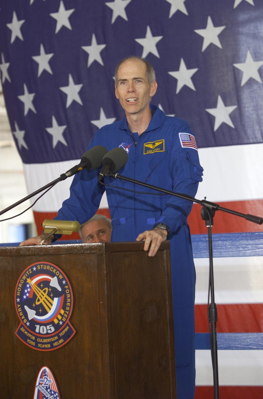 JSC2001-E-25819 (23 August 2001) --- Daniel T. Barry, STS-105 mission specialist, speaks from the podium in Hangar 990 at Ellington Field during the STS-105 and Expedition Two crew return ceremonies. The STS-105 crew delivered the Expedition Three crew and supplies to the International Space Station (ISS) and brought the Expedition Two crew back to Earth.
