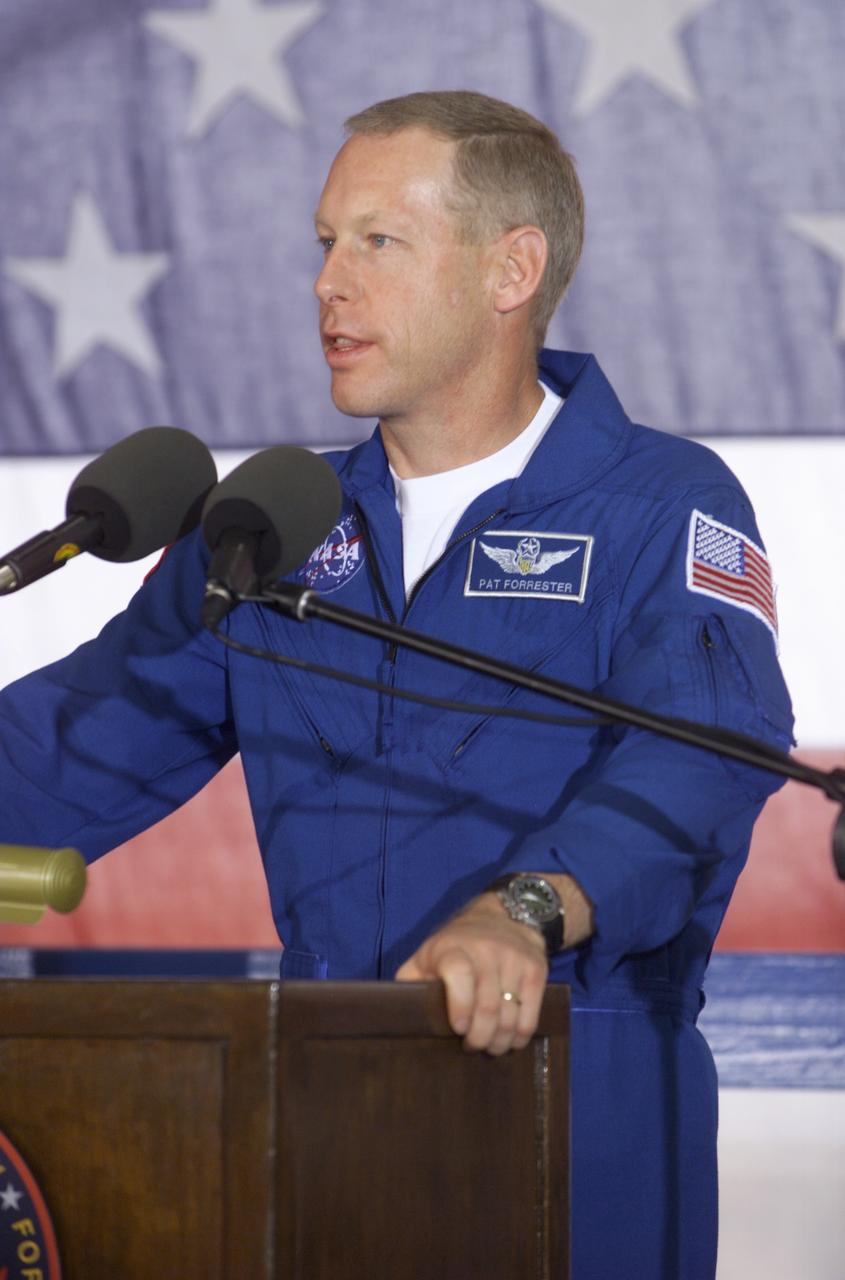 JSC2001-E-25820 (23 August 2001) --- Patrick G. Forrester, STS-105 mission specialist, speaks from the podium in Hangar 990 at Ellington Field during the STS-105 and Expedition Two crew return ceremonies. The STS-105 crew delivered the Expedition Three crew and supplies to the International Space Station (ISS) and brought the Expedition Two crew back to Earth.